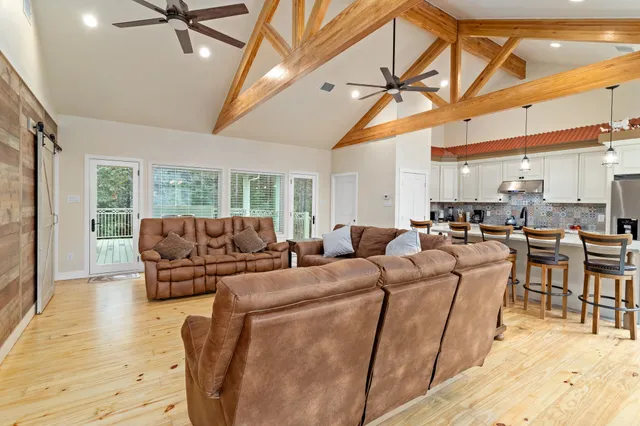 a living room with furniture a ceiling fan and a rug