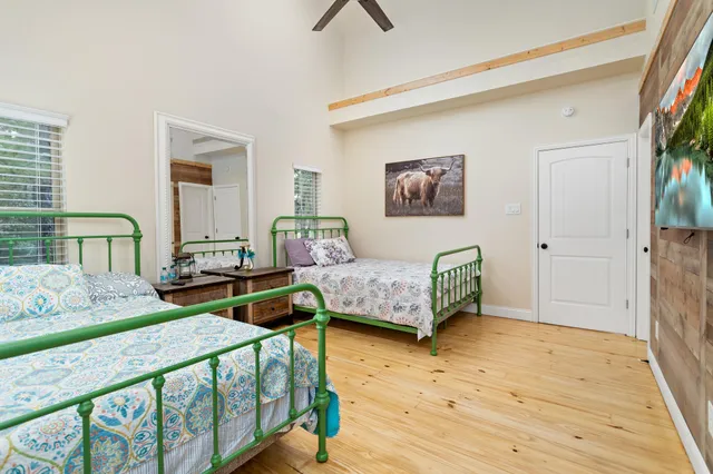 a bedroom with two beds and a large window