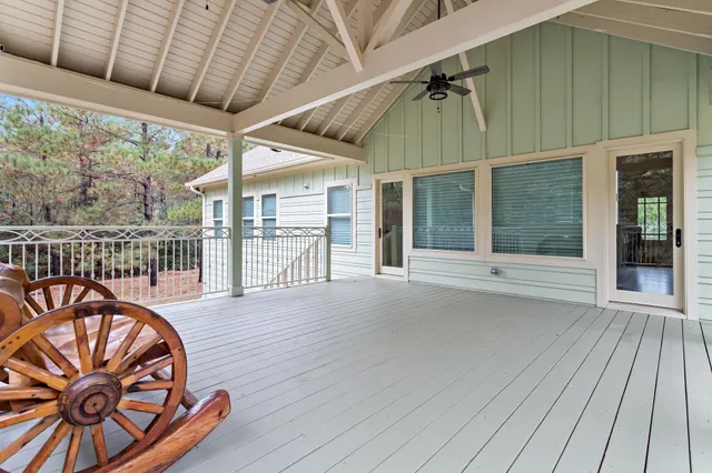 a living room with furniture a ceiling fan and a rug
