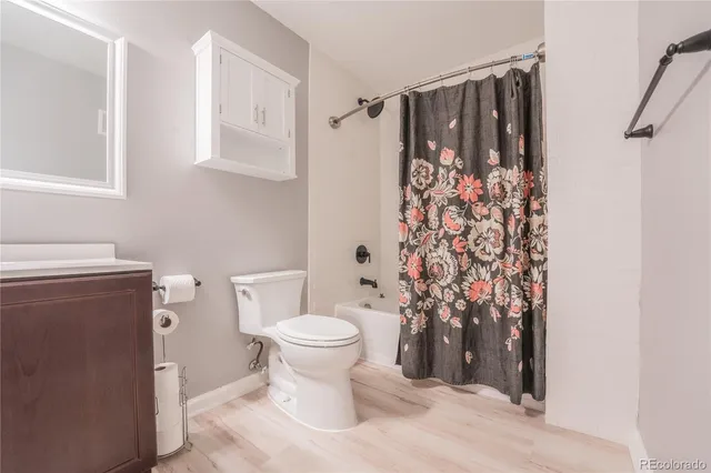 a bathroom with a toilet sink and shower