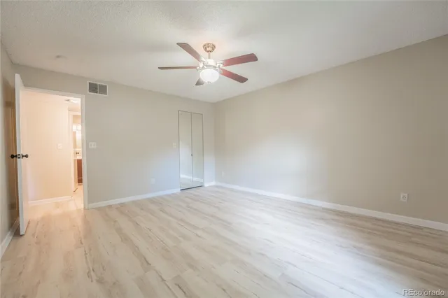 a view of an empty room with wooden floor