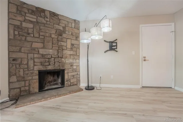 a view of empty room with a fireplace