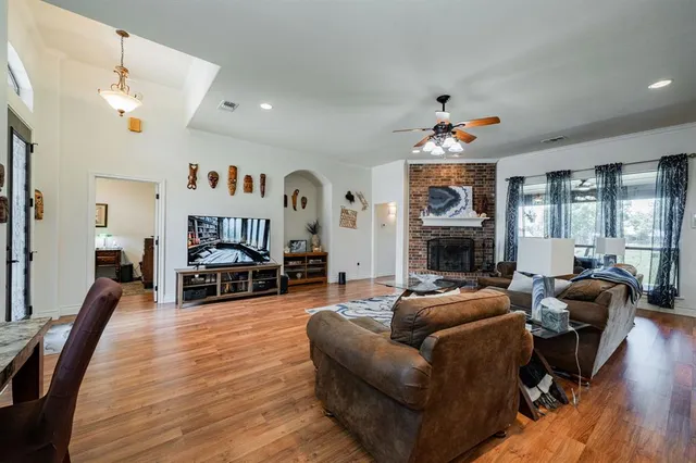 a living room with furniture a fireplace and a flat screen tv