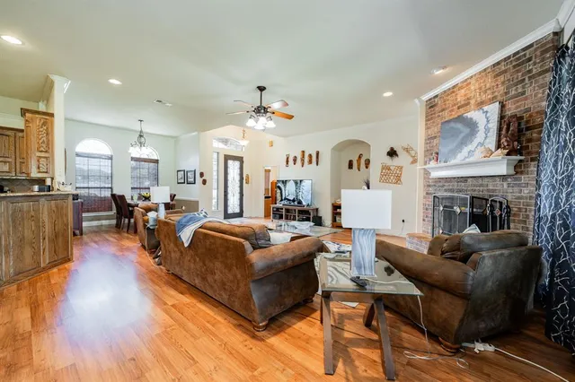 a living room with fireplace furniture and a chandelier