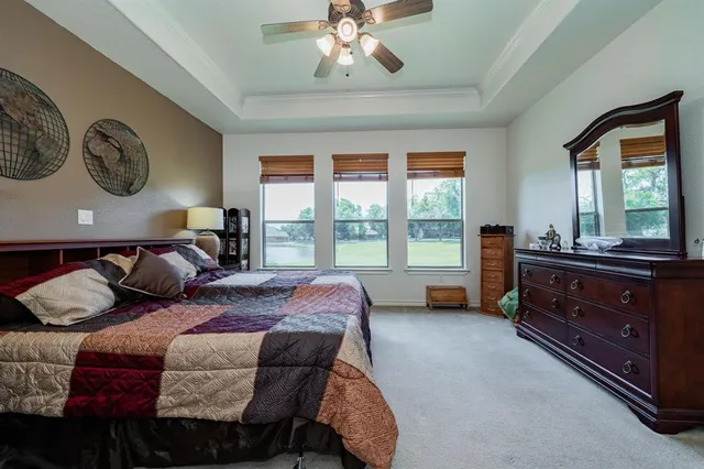 a bed room with a bed and a large window