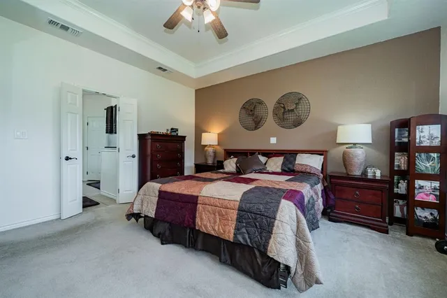 a bedroom with bed and a chandelier