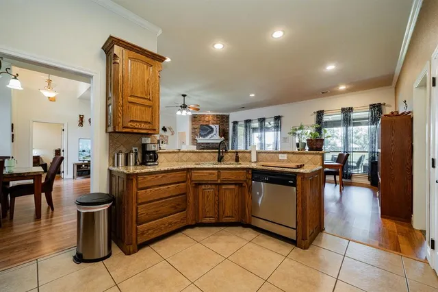 a kitchen with stainless steel appliances granite countertop a refrigerator and a stove top oven