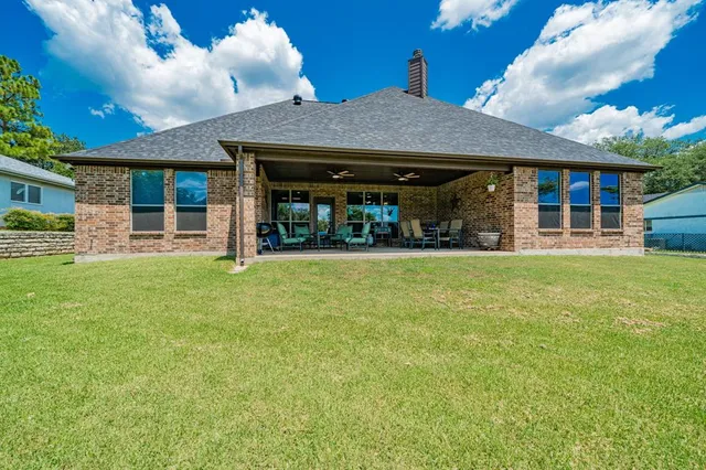a view of a house with a yard and sitting area