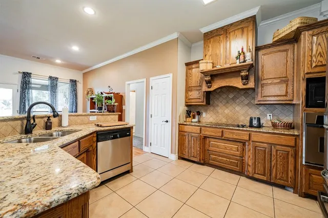 a kitchen with stainless steel appliances granite countertop a sink and stove