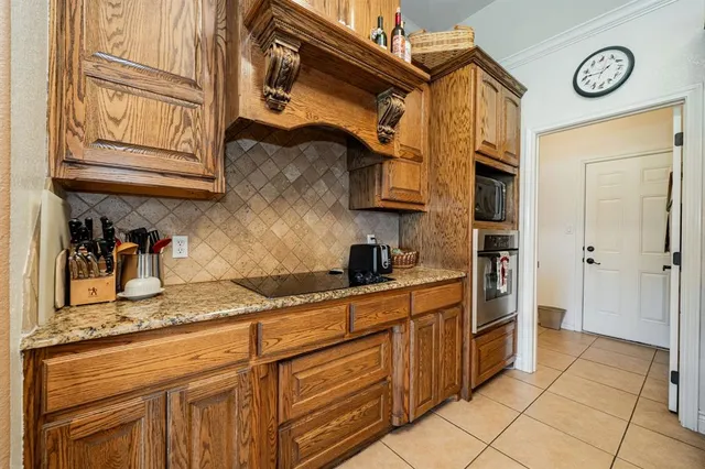 a kitchen with stainless steel appliances granite countertop a sink and cabinets