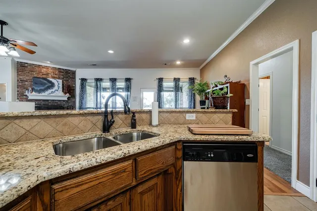 a kitchen with granite countertop lots of counter top space and windows
