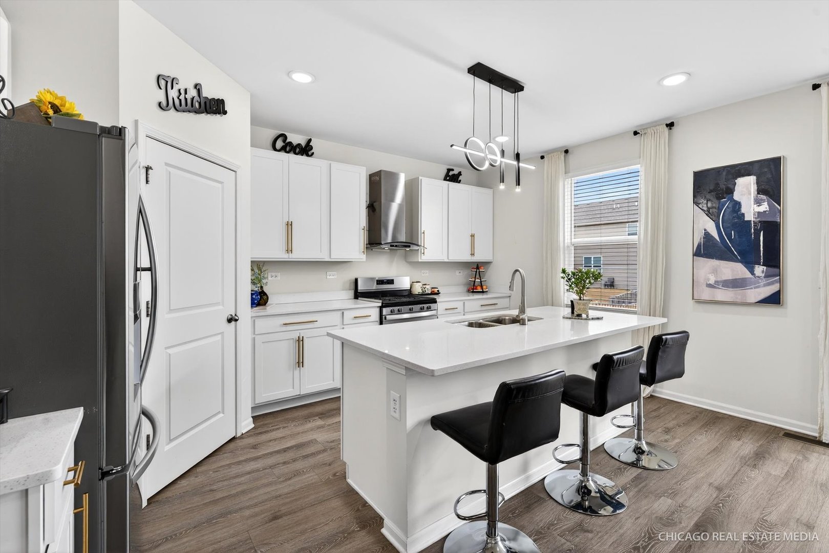 1571 Middleton Road Pingree Grove, IL 60140 - Photo 5 of 35 a kitchen with stainless steel appliances granite countertop a refrigerator a sink dishwasher a stove and white countertops with wooden floor