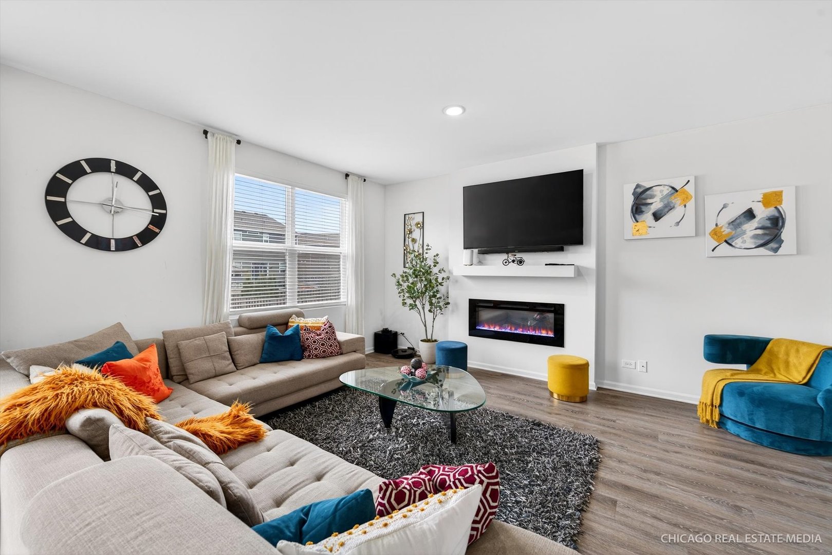 1571 Middleton Road Pingree Grove, IL 60140 - Photo 10 of 35 a living room with furniture a flat screen tv and a fireplace