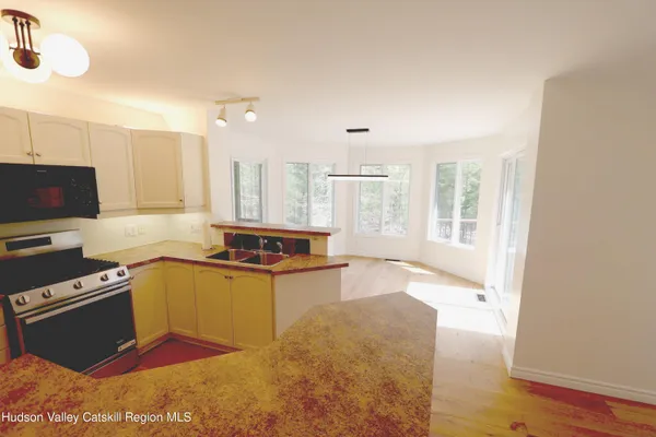 a kitchen with a stove a sink and a microwave