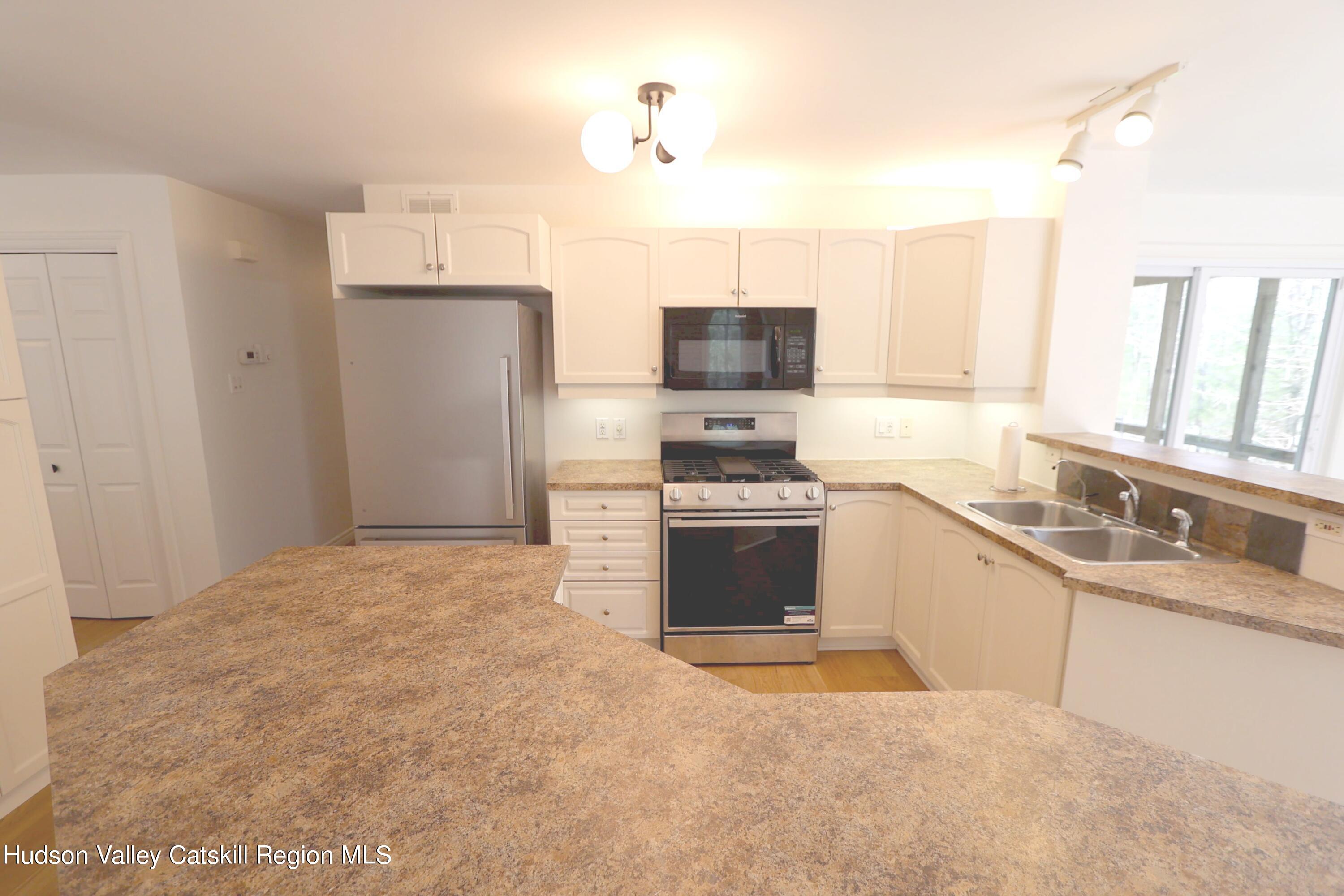 63 Lawrence Hill Road Accord, NY 12404 - Photo 12 of 27 a kitchen with stainless steel appliances granite countertop a refrigerator stove top oven a sink and dishwasher