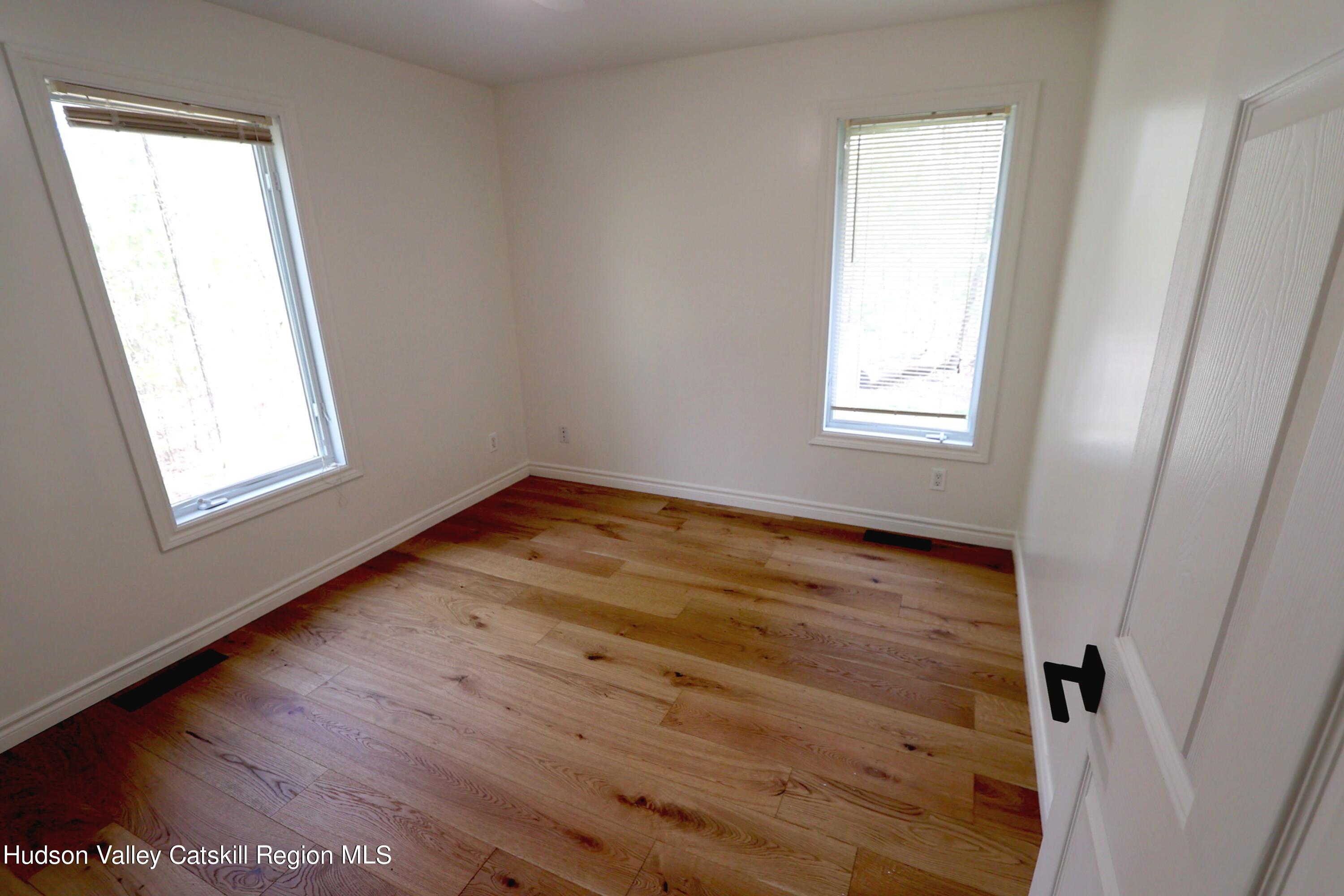63 Lawrence Hill Road Accord, NY 12404 - Photo 18 of 27 an empty room with wooden floor and windows