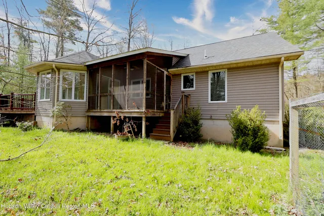 a view of a house with yard and sitting area