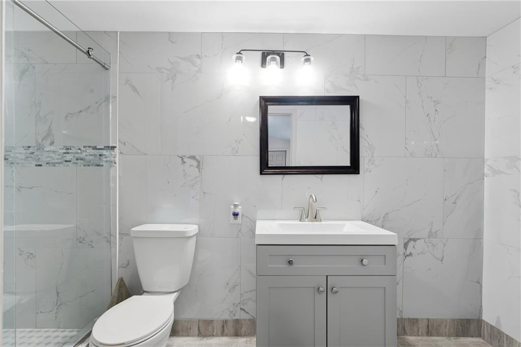 1295 Double Bridges Road Winder, GA 30680 - Photo 20 of 57 a bathroom with a toilet sink and mirror