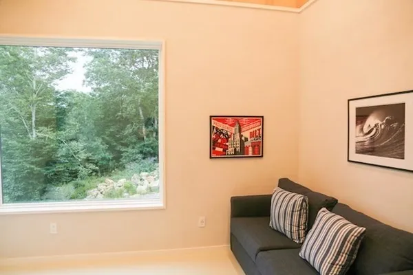 a view of a bedroom with furniture and a window