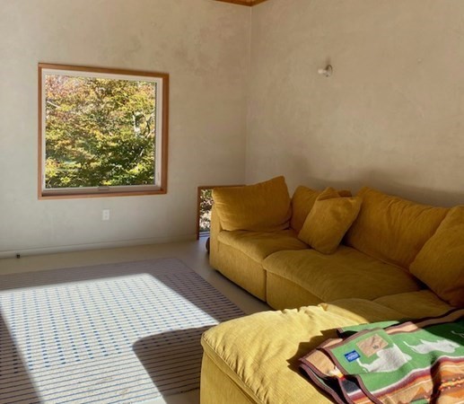 29 Bea Lane, Unit 1 West Tisbury, MA 02568 - Photo 7 of 10 a blue bed sitting in a bedroom next to a window