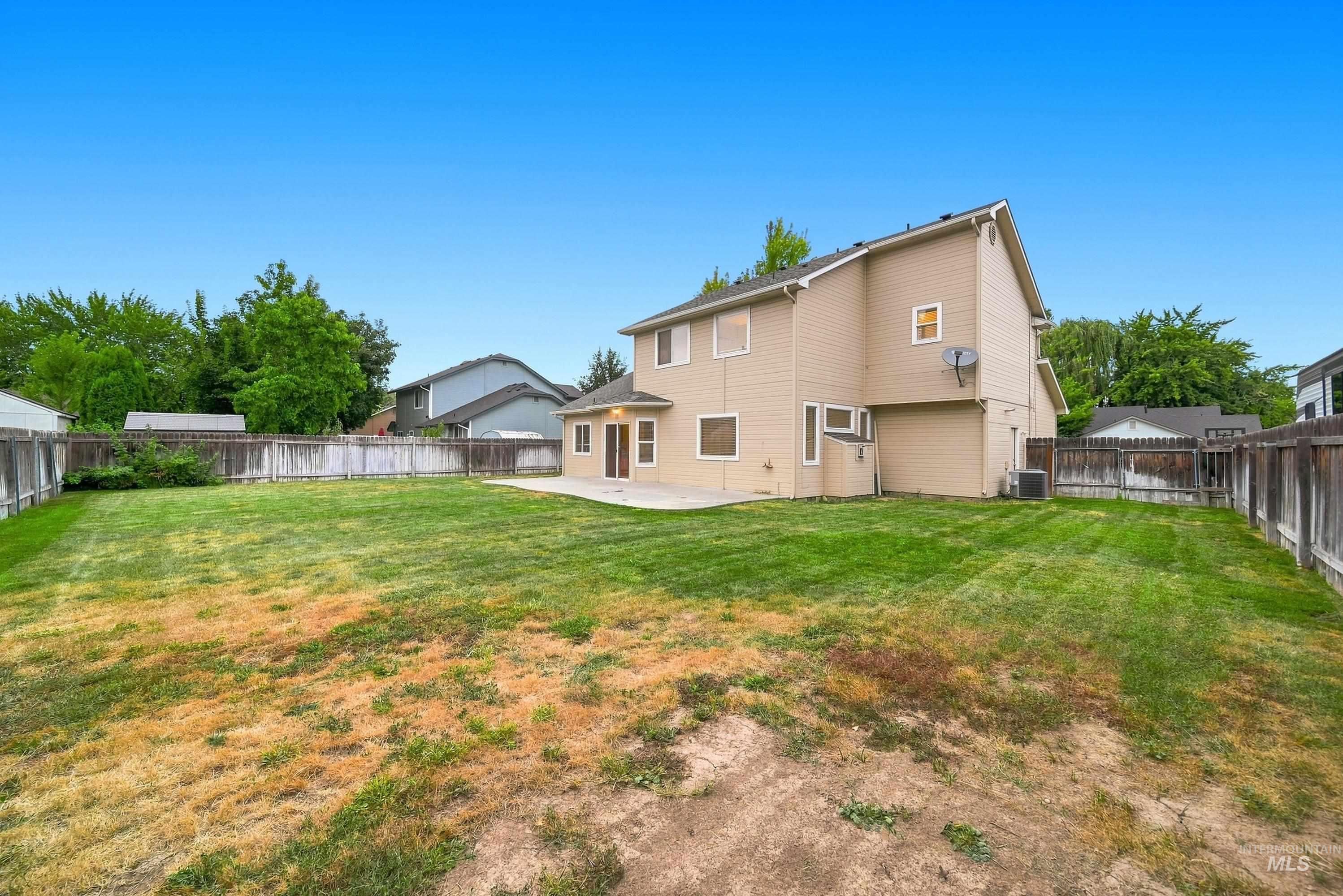 919 East Hawk Street Meridian, ID 83646 - Photo 30 of 31 Expansive backyard space with a full perimeter fence and a concrete patio