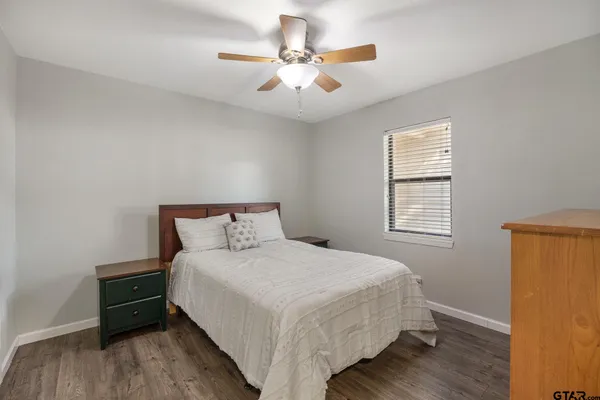 a bedroom with a bed and a ceiling fan