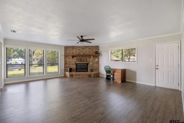 a view of an empty room with fire place and a fireplace