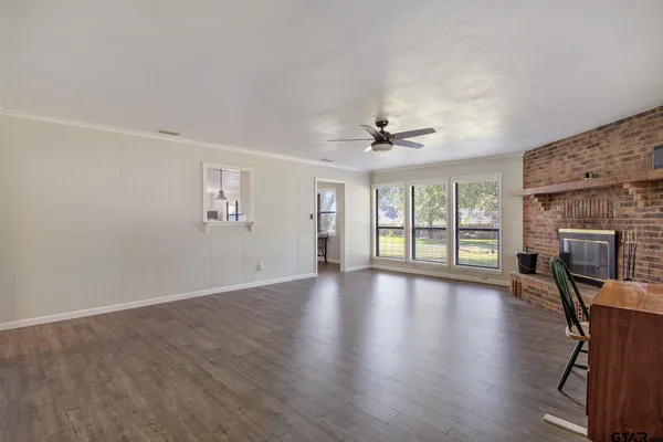 a dining room that has a table and chairs in it with a window