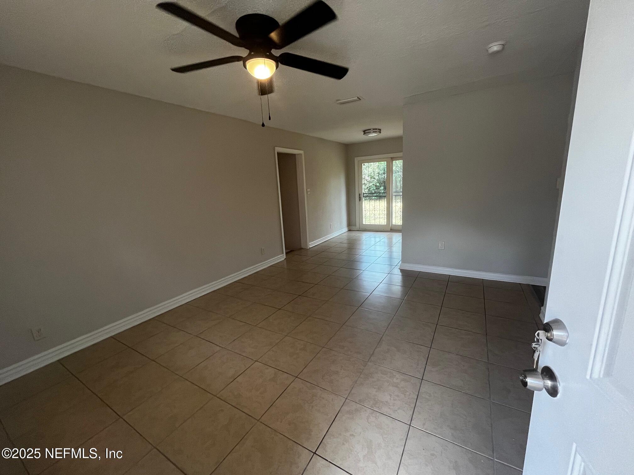 3970 Winton Drive Jacksonville, FL 32208 - Photo 2 of 5 a view of an empty room and window