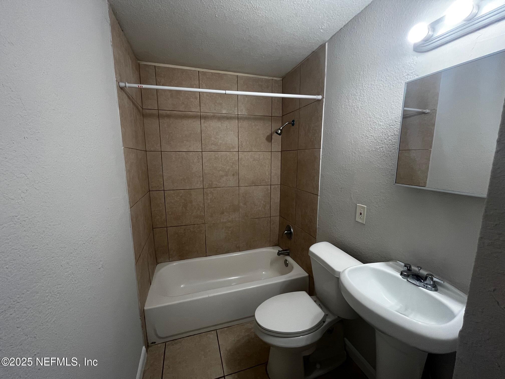 3970 Winton Drive Jacksonville, FL 32208 - Photo 5 of 5 a bathroom with a sink toilet and shower