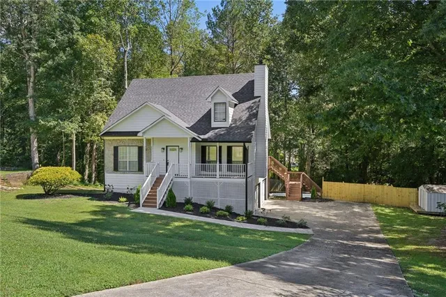 a front view of house with yard and green space