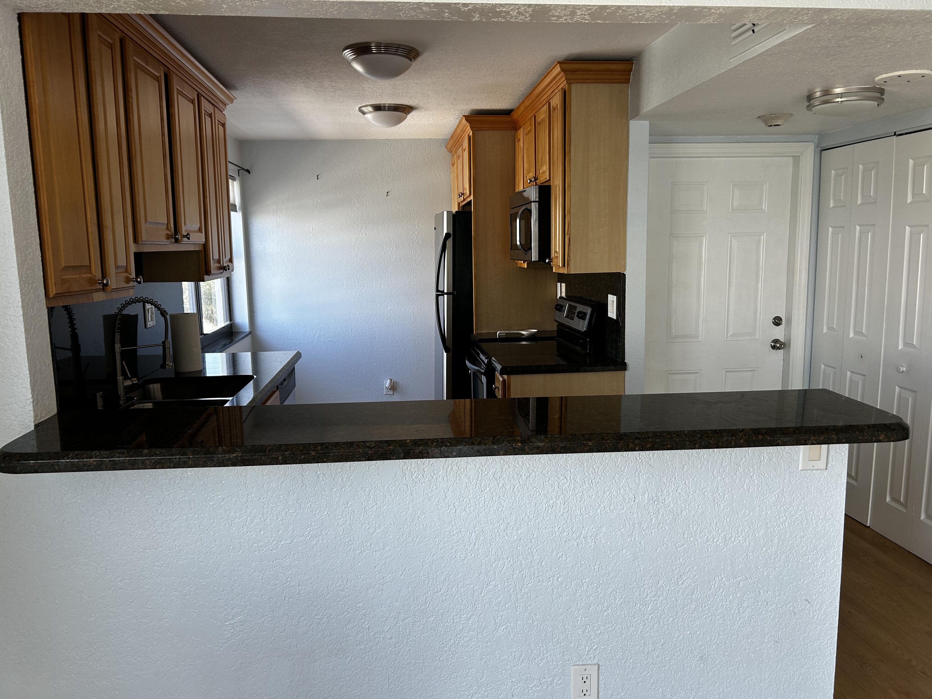 1401 North Riverside Drive, Unit 307 Pompano Beach, FL 33062 - Photo 21 of 29 kitchen from living room