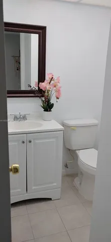 a bathroom with a sink a toilet and mirror