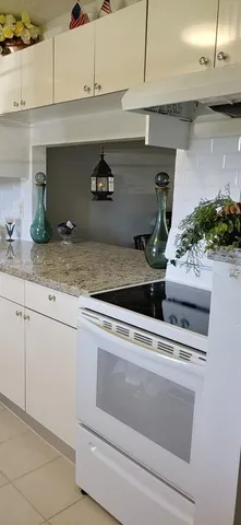 a kitchen with a stove and cabinets