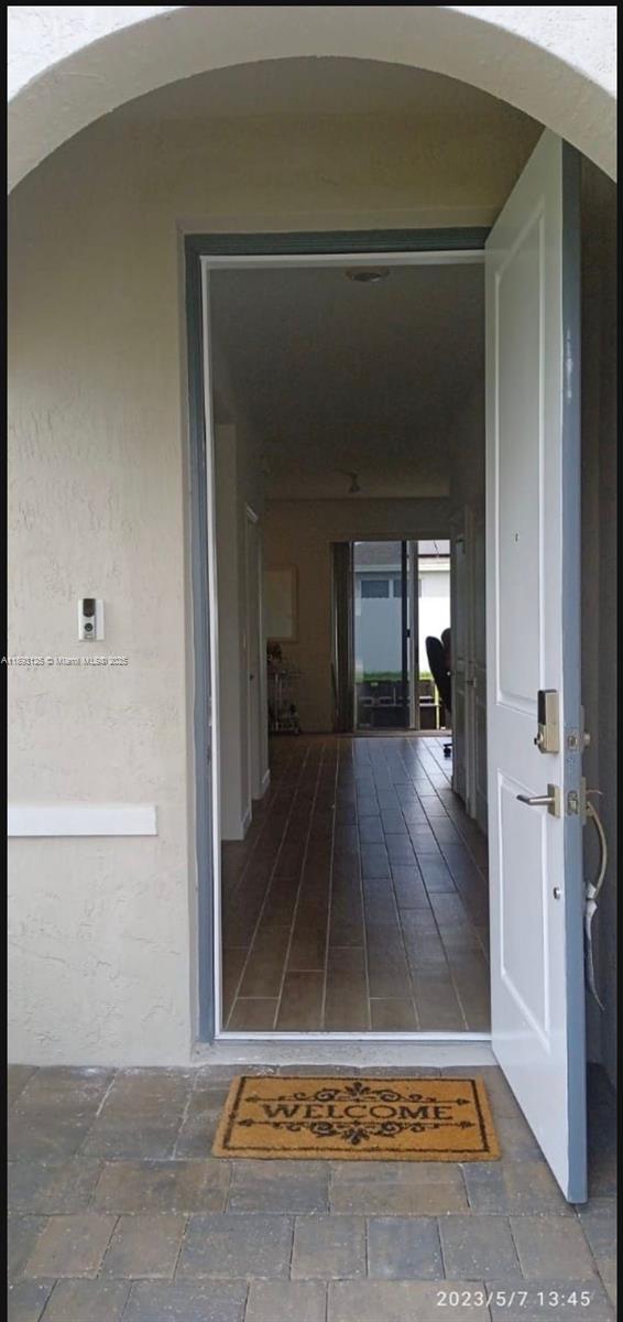 13219 Southwest 270th Terrace Homestead, FL 33032 - Photo 11 of 11 a view of a hallway with wooden floor and a living room
