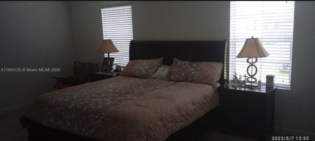 13219 Southwest 270th Terrace Homestead, FL 33032 - Photo 2 of 11 a bedroom with a bed and a window