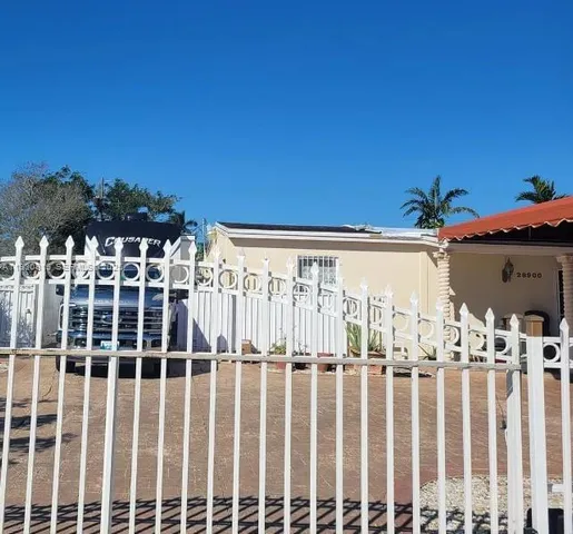 a kitchen with stainless steel appliances granite countertop a sink a stove a microwave a refrigerator and white cabinets