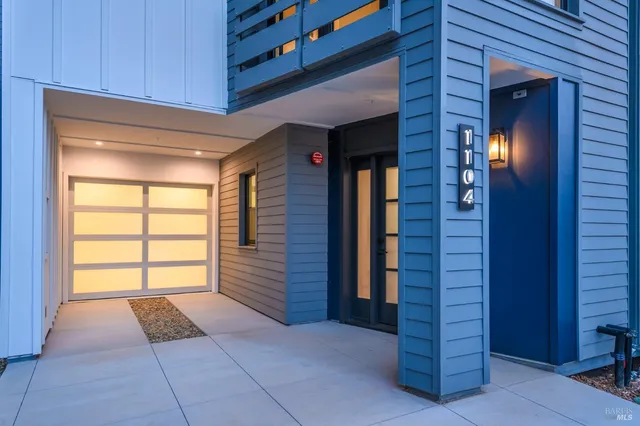 a view of an empty room with a windows and dresser