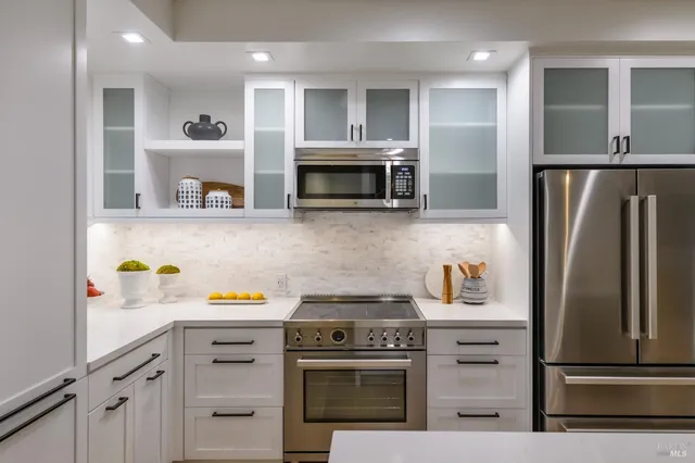 a kitchen with refrigerator and cabinets