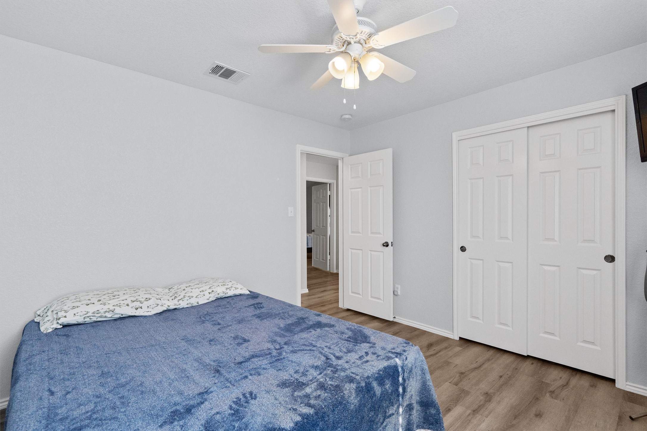 1833 Thompson Trail Round Rock, TX 78664 - Photo 27 of 40 Hardwood-style flooring and a ceiling fan enhance comfort in this naturally illuminated bedroom space.