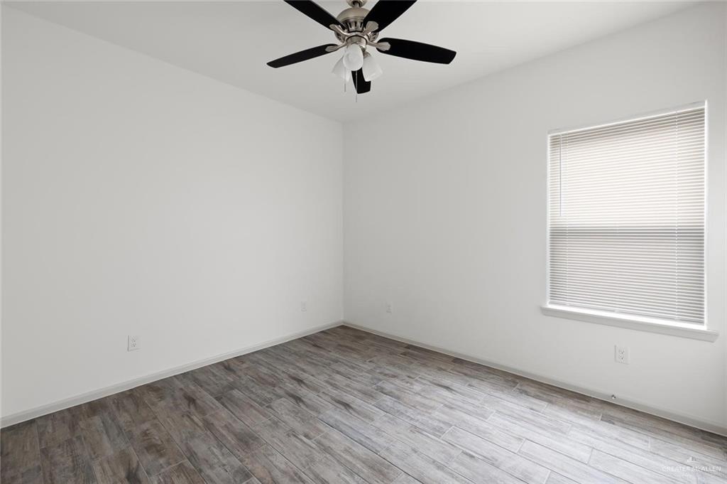 1308 Valle Vista Street, Unit 2 Alamo, TX 78516 - Photo 12 of 15 an empty room with a window and a ceiling fan