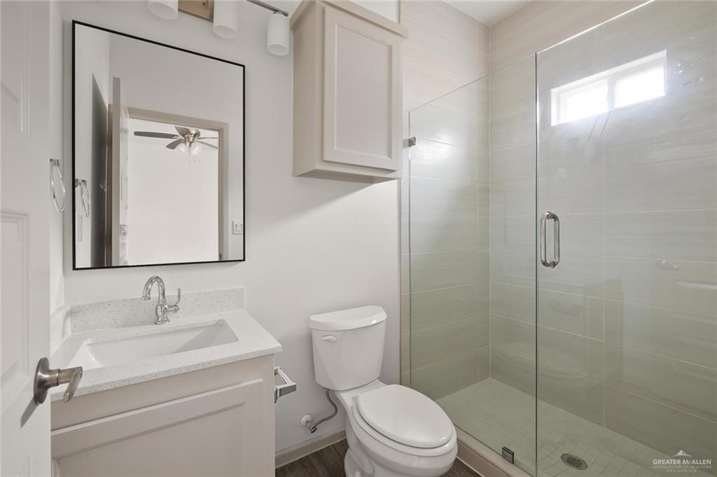 1308 Valle Vista Street, Unit 2 Alamo, TX 78516 - Photo 7 of 15 a bathroom with a toilet a sink and shower