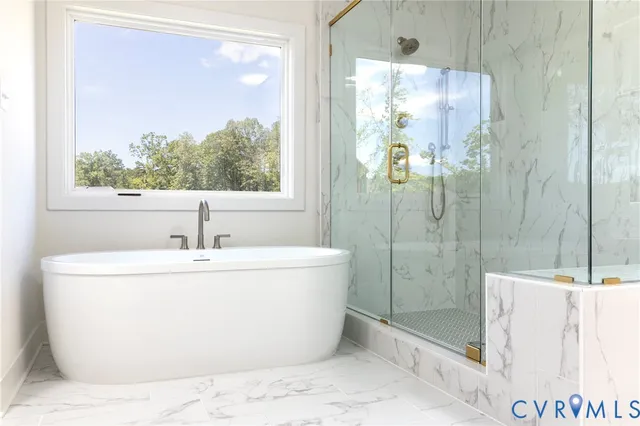 a white bath tub sitting next to a bathroom sink