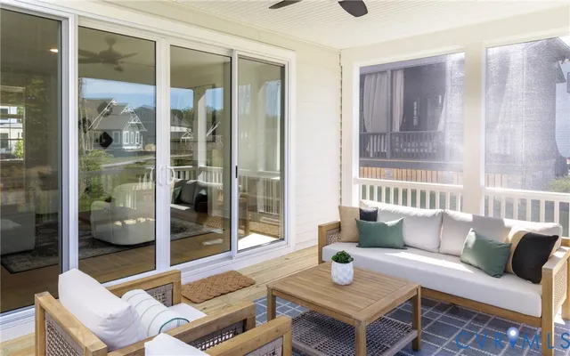 a living room with furniture and a floor to ceiling window