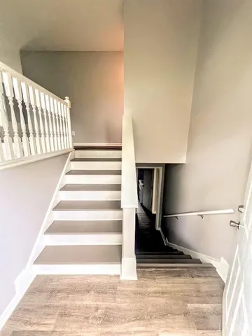 a view of entryway and hall with wooden floor