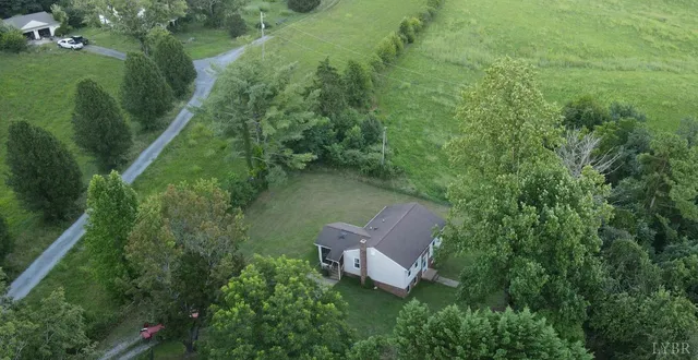 an aerial view of a house with a yard
