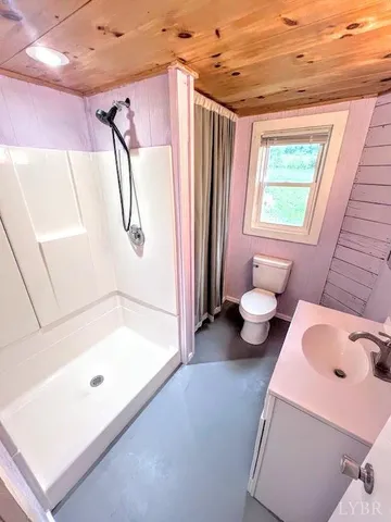 a bathroom with a tub shower and a sink