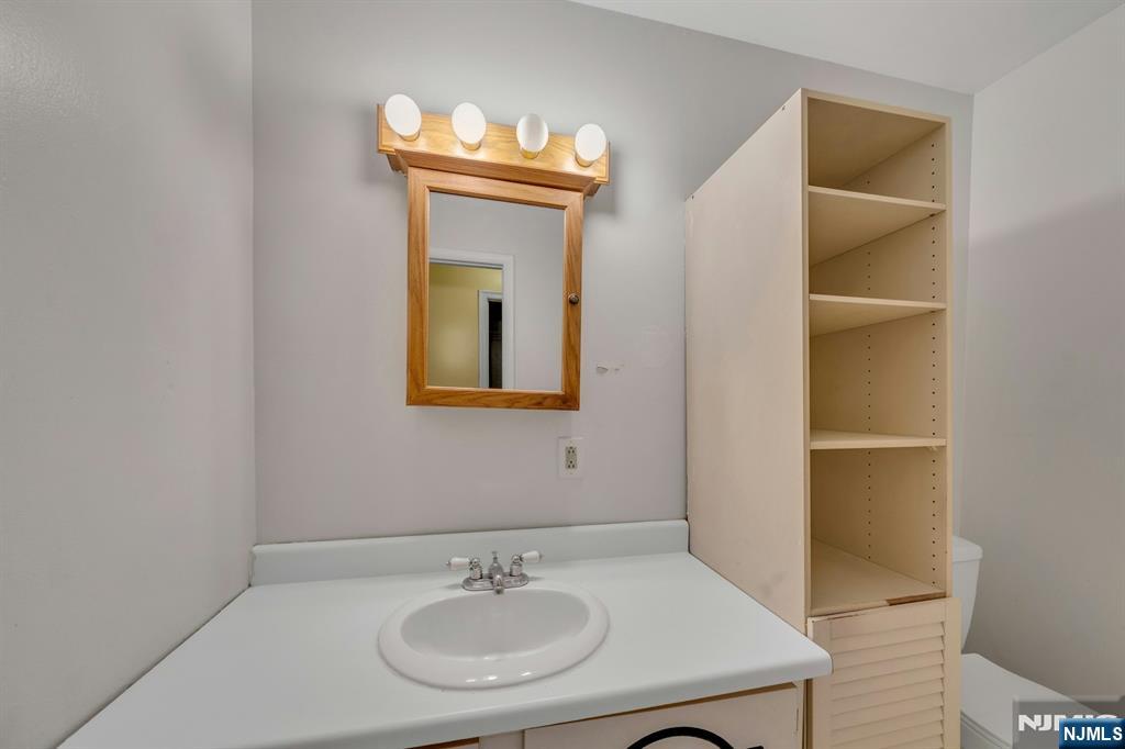 666 Mill Street, Unit C6 Belleville, NJ 07109 - Photo 15 of 25 a bathroom with a sink and a mirror