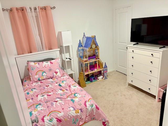 464 Reverie Way Ferris, TX 75125 - Photo 11 of 21 a bedroom with a bed and a flat tv screen on dresser
