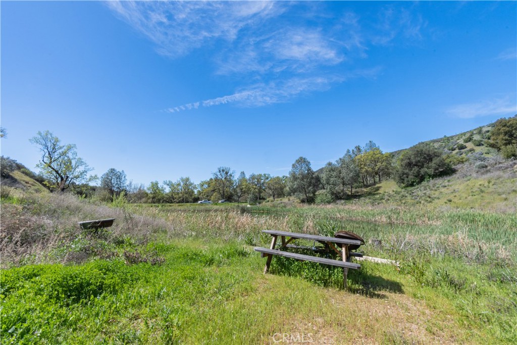 0 Av Ranch Road Greenfield, CA 93927 - Photo 15 of 26 a view of a lake with a yard and mountain